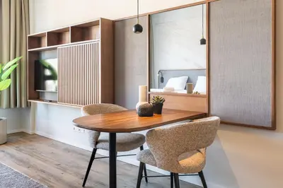 a dining room with a wooden table and chairs at Utrecht City Apartments - Huizingalaan in Utrecht