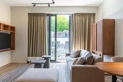 a living room with a couch and a table at Utrecht City Apartments - Huizingalaan in Utrecht