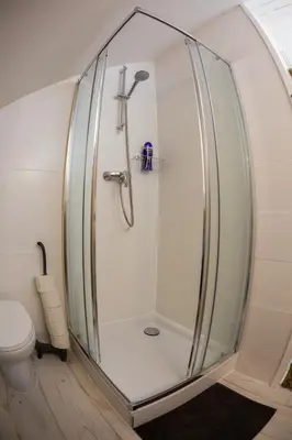 a shower with a glass enclosure in a bathroom at Silver Moon Bed & Breakfast in Voorschoten