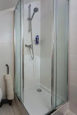 a shower with a glass door in a bathroom at Silver Moon Bed & Breakfast in Voorschoten