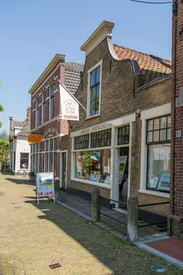 a brick building with a sign in front of it at Silver Moon Bed & Breakfast in Voorschoten