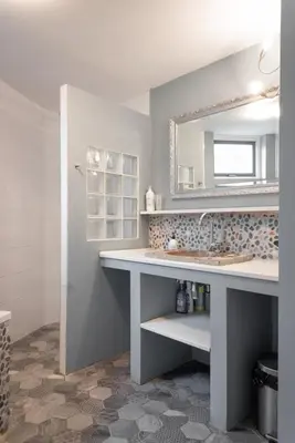 a bathroom with a sink and a mirror at Silver Moon Bed & Breakfast in Voorschoten