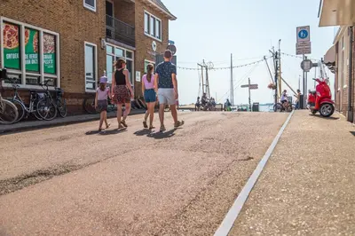 a group of people walking down a street at EuroParcs Poort van Amsterdam in Uitdam