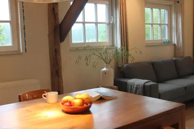 a living room with a table with a bowl of fruit on it at Rest & Rust in Werkhoven