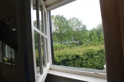 a window with a view of a green field at Rest & Rust in Werkhoven