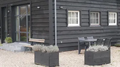a table and chairs in front of a building at Rest & Rust in Werkhoven
