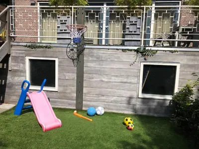 a playground with a basketball hoop and a ball at Coastal Dreaming in Egmond aan Zee