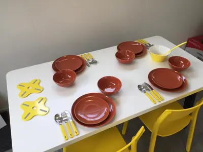 a table with brown plates and utensils on it at Coastal Dreaming in Egmond aan Zee