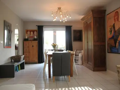 a kitchen with a table and a dining room at Groet Villa Stay with Garden Views in Groet