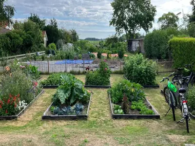 a garden with several plots of vegetables and flowers at Groet Villa Stay with Garden Views in Groet