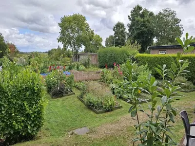 a garden with many plants and bushes at Groet Villa Stay with Garden Views in Groet
