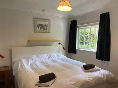a bedroom with a bed with two towels on it at Holiday Home in Bergen near the Beach in Bergen