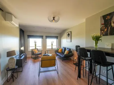 a living room with a couch and a table at Apartment in Katwijk near the Beach in Katwijk