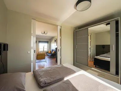 a bedroom with a bed and a large mirror at Apartment in Katwijk near the Beach in Katwijk