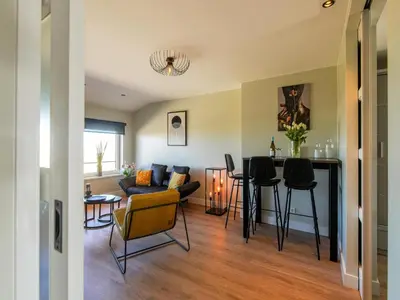 a living room with a couch and a table at Apartment in Katwijk near the Beach in Katwijk