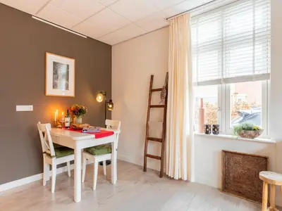 a dining room with a table and a window at Apartment in Bergen near Sandy Beaches in Bergen