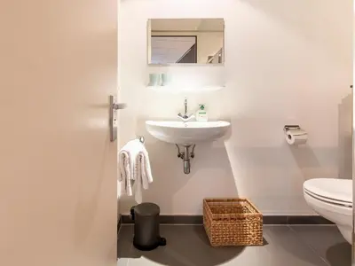 a white bathroom with a sink and a toilet at Apartment in Bergen near Sandy Beaches in Bergen