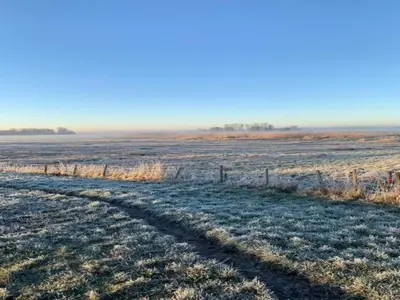 a frosty field with a fence in the foreground at Apartment in Bergen near Sandy Beaches in Bergen