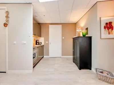 a kitchen with a black cabinet in a room at Apartment in Bergen near Schoorl Dunes in Bergen