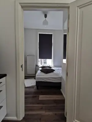 a bedroom with a bed and a window at Mio appartementen in Zandvoort