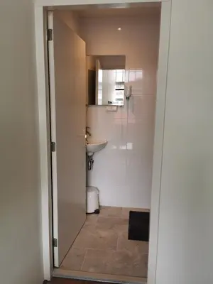 a bathroom with a toilet and a sink at Mio appartementen in Zandvoort