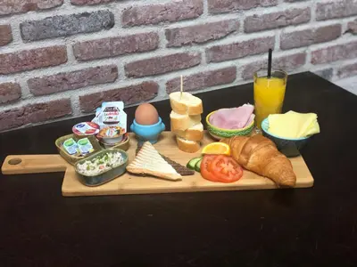 a tray of food on a table with eggs and bread at Mio appartementen in Zandvoort