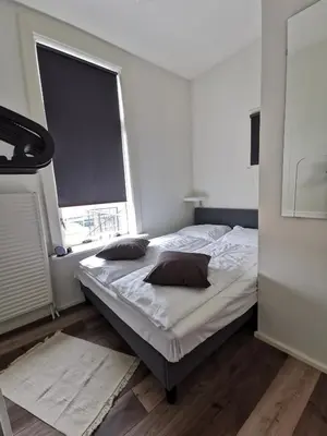 a bedroom with a bed with two pillows on it at Mio appartementen in Zandvoort
