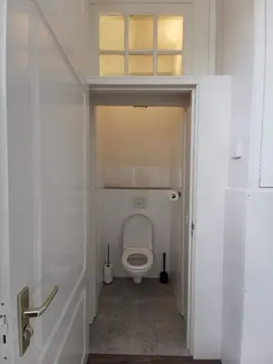 a bathroom with a white toilet in a room at Mio appartementen in Zandvoort