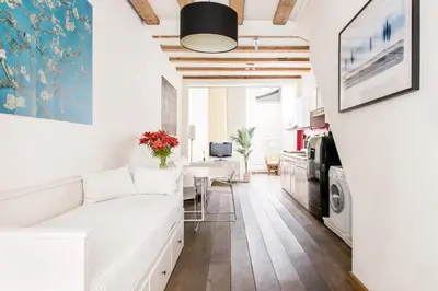 a living room with a white couch and a table at GH Amsterdam in Amsterdam