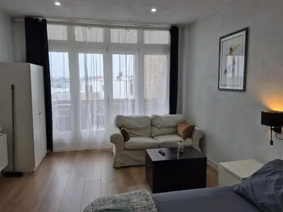 a living room with a couch and a table at Studio Slijterij Zandvoort in Zandvoort