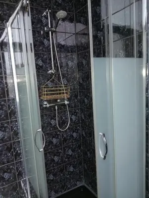 a shower with a basket on the wall in a bathroom at Studio Slijterij Zandvoort in Zandvoort