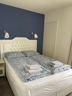 a bedroom with a bed with two towels on it at Dreamview Apartment in Zandvoort