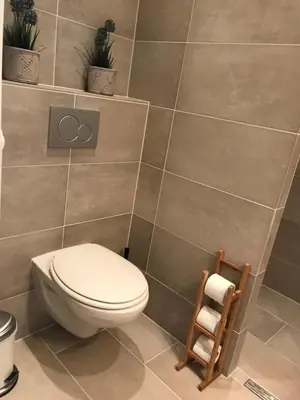 a bathroom with a toilet and some plants at Dreamview Apartment in Zandvoort