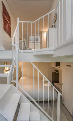 a white spiral staircase in a house at Luxury Flower Market Apartment in Amsterdam