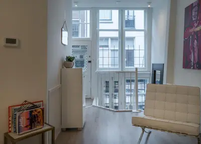 a living room with a couch and a chair at Luxury Flower Market Apartment in Amsterdam