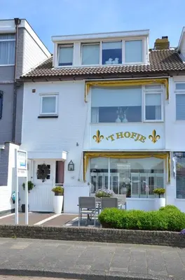 a house with a sign on the front of it at Pension 't hofje 350 meter van het strand in Noordwijk aan Zee