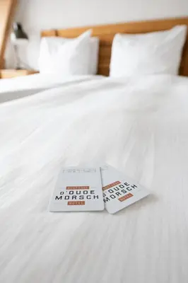 two books sitting on top of a bed at Boutique Hotel d'Oude Morsch in Leiden