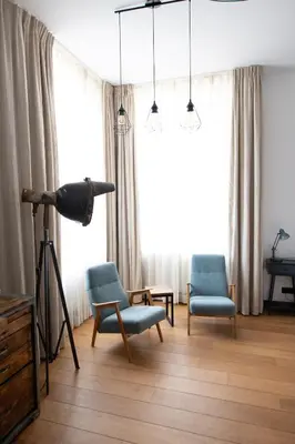 a living room with two chairs and a telescope at Boutique Hotel d'Oude Morsch in Leiden
