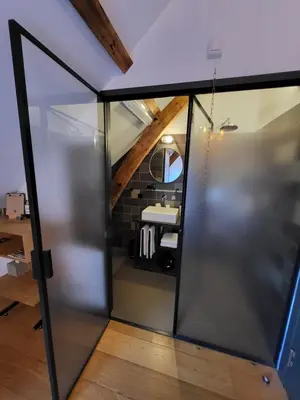 an open glass door leading into an office with a desk at Boutique Hotel d'Oude Morsch in Leiden