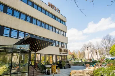 a large building with a patio in front of it at Hotel V Fizeaustraat in Amsterdam