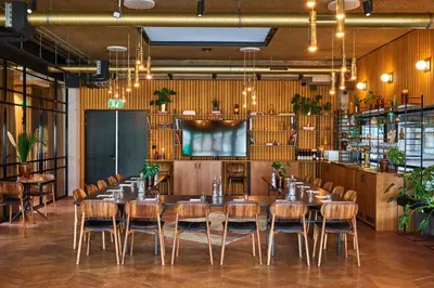 a dining room with a long table and chairs at Hotel V Fizeaustraat in Amsterdam