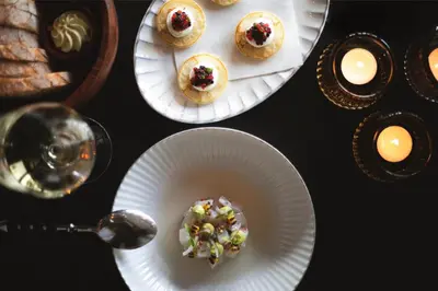 a table with plates of pastries and a glass of wine at Hotel V Fizeaustraat in Amsterdam