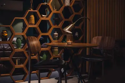 a room with a wooden wall with a table and chairs at Hotel V Fizeaustraat in Amsterdam