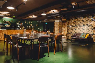 a dining room with a long table and chairs at Hotel V Fizeaustraat in Amsterdam