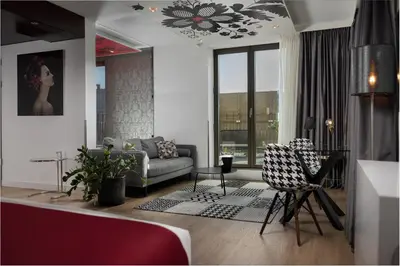 a living room with a couch and two chairs at WestCord Fashion Hotel Amsterdam in Amsterdam
