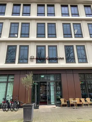 a building with bikes parked outside of it at Camp-Inn Hotel in Amsterdam
