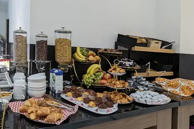 a buffet with many different types of food on a table at Camp-Inn Hotel in Amsterdam