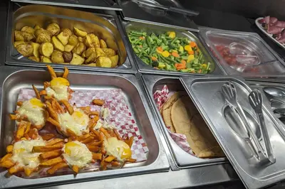 a tray of food with french fries and other foods at Camp-Inn Hotel in Amsterdam
