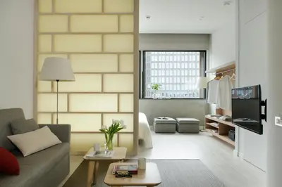 a living room with a couch and a bed at Eric Vökel Boutique Apartments - Amsterdam Suites in Amsterdam