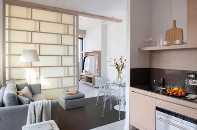 a living room and kitchen with a couch and a table at Eric Vökel Boutique Apartments - Amsterdam Suites in Amsterdam
